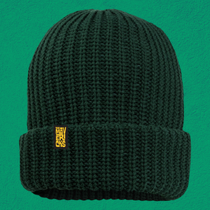 Dark green knitted beanie with a yellow tag on the folded brim.