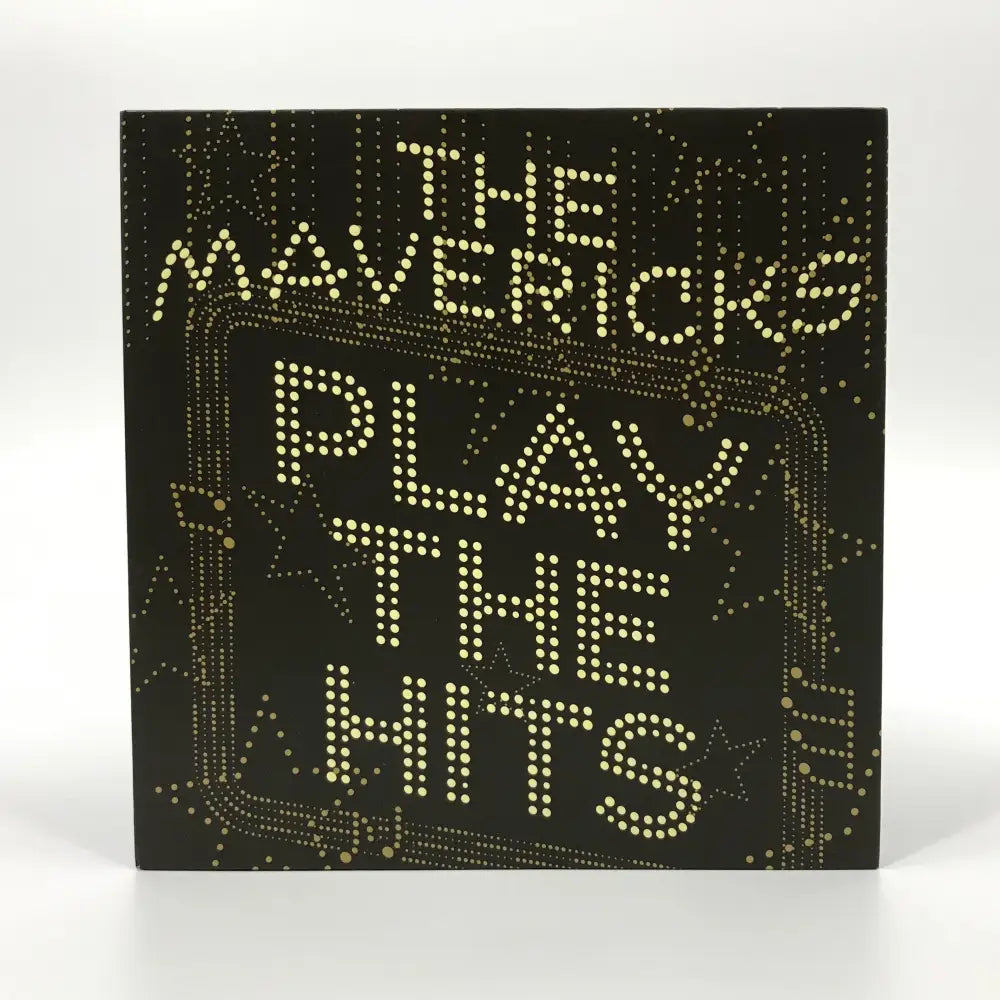 Album cover for ’Play The Hits’ by The Mavericks, featuring illuminated dot-matrix style lettering on a dark background.