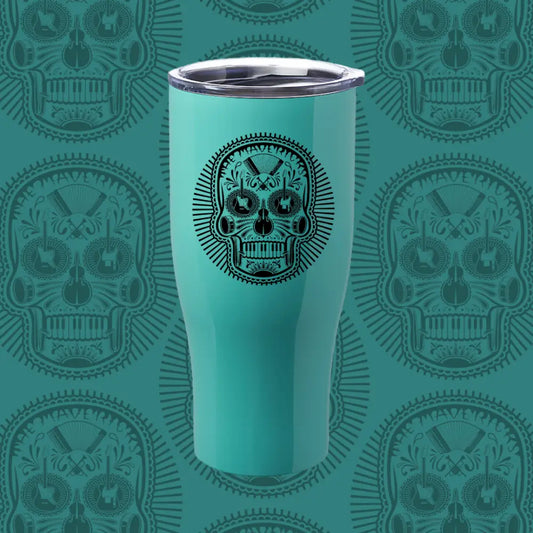 Teal tumbler with a black sugar skull design on its surface.