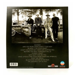 Back cover of a music album featuring a black and white photograph of four men posing next to a vintage car, with a track listing below.